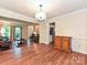 Open living area with hardwood floors, natural light, and view to entry staircase and kitchen at 3612 Woodnotch Ct, Charlotte, NC 28269