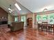 Open living and dining area with hardwood floors, fireplace, and large windows at 3612 Woodnotch Ct, Charlotte, NC 28269