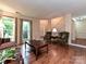 Living room with hardwood floors, staircase, large windows and traditional furnishings at 3612 Woodnotch Ct, Charlotte, NC 28269