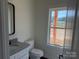 Bright bathroom with granite countertop, white vanity, and window view at 4034 Daugherty Rd, China Grove, NC 28023