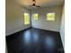 Inviting bedroom with dark hardwood floors, large windows, and a ceiling fan for added comfort at 4034 Daugherty Rd, China Grove, NC 28023
