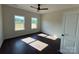 Bright bedroom with hardwood floors, ceiling fan, and windows offering natural light and a picturesque view at 4034 Daugherty Rd, China Grove, NC 28023
