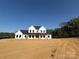 New two-story home with white siding and a dark roof, set against a blue sky at 4034 Daugherty Rd, China Grove, NC 28023