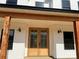Close-up of a wood double door entrance with sidelights and sconces at 4034 Daugherty Rd, China Grove, NC 28023