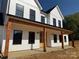 Detailed view of a home's covered front porch with wooden beams and black accents at 4034 Daugherty Rd, China Grove, NC 28023