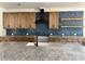 Modern kitchen boasts granite countertops, blue tile backsplash, and stainless steel hood at 4034 Daugherty Rd, China Grove, NC 28023
