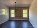 Bright living room with wood-paneled accent wall and large windows providing natural light at 4034 Daugherty Rd, China Grove, NC 28023