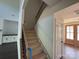 Elegant staircase features dark iron railings and wood steps and banister at 4034 Daugherty Rd, China Grove, NC 28023