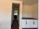 Open dining area with modern storage, dark hardwood floors, and a sliding barn door at 4040 Daugherty Rd, China Grove, NC 28023