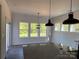 Bright kitchen with a large island, granite countertops, modern lighting, and a view to the backyard at 4040 Daugherty Rd, China Grove, NC 28023