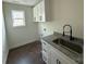Laundry room featuring a sink, upper and lower cabinets, and a window at 4040 Daugherty Rd, China Grove, NC 28023