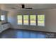 Bright living room with hardwood floors, multiple windows for natural light, and custom built-in cabinetry at 4040 Daugherty Rd, China Grove, NC 28023