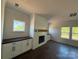 Living room featuring built-ins, a shiplap fireplace, and abundant natural light at 4040 Daugherty Rd, China Grove, NC 28023