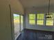 Bright living room featuring white shiplap walls, dark floors, and multiple windows at 4040 Daugherty Rd, China Grove, NC 28023