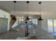 Open-concept living room with modern lighting, granite countertops, and a view to the backyard at 4040 Daugherty Rd, China Grove, NC 28023