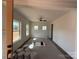 Bright living room featuring a ceiling fan and large windows offering nice natural light at 4040 Daugherty Rd, China Grove, NC 28023