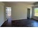 Well-lit bedroom with dark hardwood flooring, neutral walls, and windows offering exterior views, promoting a serene atmosphere at 4040 Daugherty Rd, China Grove, NC 28023