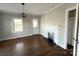 Inviting bedroom with hardwood floors, a decorative fireplace, and ample natural light, creating a relaxing space at 406 S Catawba St, Lancaster, SC 29720
