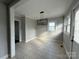 Bright dining room with tile floors, modern lighting, and natural light, ideal for Gathering meals at 406 S Catawba St, Lancaster, SC 29720
