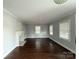 Spacious living room featuring hardwood floors, large windows, and a decorative fireplace, perfect for relaxation at 406 S Catawba St, Lancaster, SC 29720