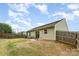 The house has a fenced backyard with a patio, chairs, and solar panels atop the roof at 4219 Mackinnon Dr, Charlotte, NC 28214