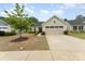 Single-Gathering home with light siding, a two-car garage, and manicured landscaping at 4219 Mackinnon Dr, Charlotte, NC 28214