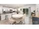 Bright kitchen features white cabinetry, stainless steel appliances, granite countertops, and a cozy dining area at 4219 Mackinnon Dr, Charlotte, NC 28214