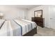 Serene bedroom with a large bed, dresser with a mirror, and neutral decor, providing a relaxing space at 4219 Mackinnon Dr, Charlotte, NC 28214