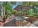 Well-manicured backyard with brick patio and outdoor kitchen, creating an ideal space for gatherings at 423 N Pine St, Charlotte, NC 28202