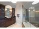 Luxurious bathroom with wood cabinetry and a glass-enclosed shower at 423 N Pine St, Charlotte, NC 28202