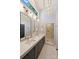 Modern bathroom with a double sink vanity, elegant gold fixtures, and a glass-enclosed shower, offering a spa-like experience at 423 N Pine St, Charlotte, NC 28202