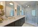 Luxurious bathroom with marble walk-in shower, dual sinks, and modern gold fixtures, exuding spa-like elegance at 423 N Pine St, Charlotte, NC 28202