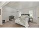 Bright bedroom with neutral decor, a gray dresser, and two windows at 423 N Pine St, Charlotte, NC 28202