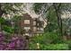 Charming exterior view of the brick home surrounded by lush greenery at 423 N Pine St, Charlotte, NC 28202
