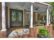 Charming front porch with detailed door, decorative pillars, and brick accents, offering curb appeal at 423 N Pine St, Charlotte, NC 28202