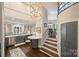 Hallway featuring an adjacent kitchen with modern design and fixtures at 423 N Pine St, Charlotte, NC 28202