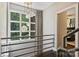 Bright hallway with a large window, modern lighting, and railing, showcasing natural light and modern design at 423 N Pine St, Charlotte, NC 28202