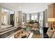 Spacious living room with grand piano, large windows, and elegant furnishings, creating a sophisticated space at 423 N Pine St, Charlotte, NC 28202