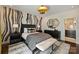Chic bedroom featuring an accent wall, stylish lighting, and a comfortable king-size bed, offering a luxurious retreat at 423 N Pine St, Charlotte, NC 28202