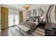 Elegant bedroom with balcony access, patterned wallpaper, and stylish decor, creating a cozy and sophisticated space at 423 N Pine St, Charlotte, NC 28202