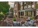 This outdoor patio is brick paved with an outdoor dining table, grill, and outdoor furniture at 423 N Pine St, Charlotte, NC 28202