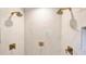 Contemporary shower featuring marble tile, double shower heads, and gold hardware at 423 N Pine St, Charlotte, NC 28202
