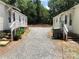 View of backyard area, showing gravel and the exteriors of both homes at 424 Skyland Ave, Charlotte, NC 28205