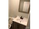 Close-up of bathroom with dark hardware, wood cabinet, and white countertops at 424 Skyland Ave, Charlotte, NC 28205