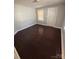 Bright bedroom featuring hardwood floors, window, and white door at 424 Skyland Ave, Charlotte, NC 28205