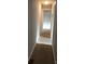 Narrow hallway with carpeted floor and light gray walls leading to a bright doorway at 424 Skyland Ave, Charlotte, NC 28205