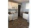 Well-lit kitchen features white cabinetry, laminate counters, and modern appliances including a microwave and stove at 424 Skyland Ave, Charlotte, NC 28205