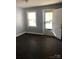 Cozy living room with dark laminate floors, natural light, and neutral paint colors; perfect starter home at 424 Skyland Ave, Charlotte, NC 28205