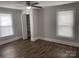 Bedroom with vinyl floors, closet, ceiling fan, window, white walls, and white trim at 507 Chrysler St, Kannapolis, NC 28083