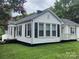 A lovely home exterior featuring crisp white siding, black shutters, and a cozy front porch at 507 Chrysler St, Kannapolis, NC 28083
